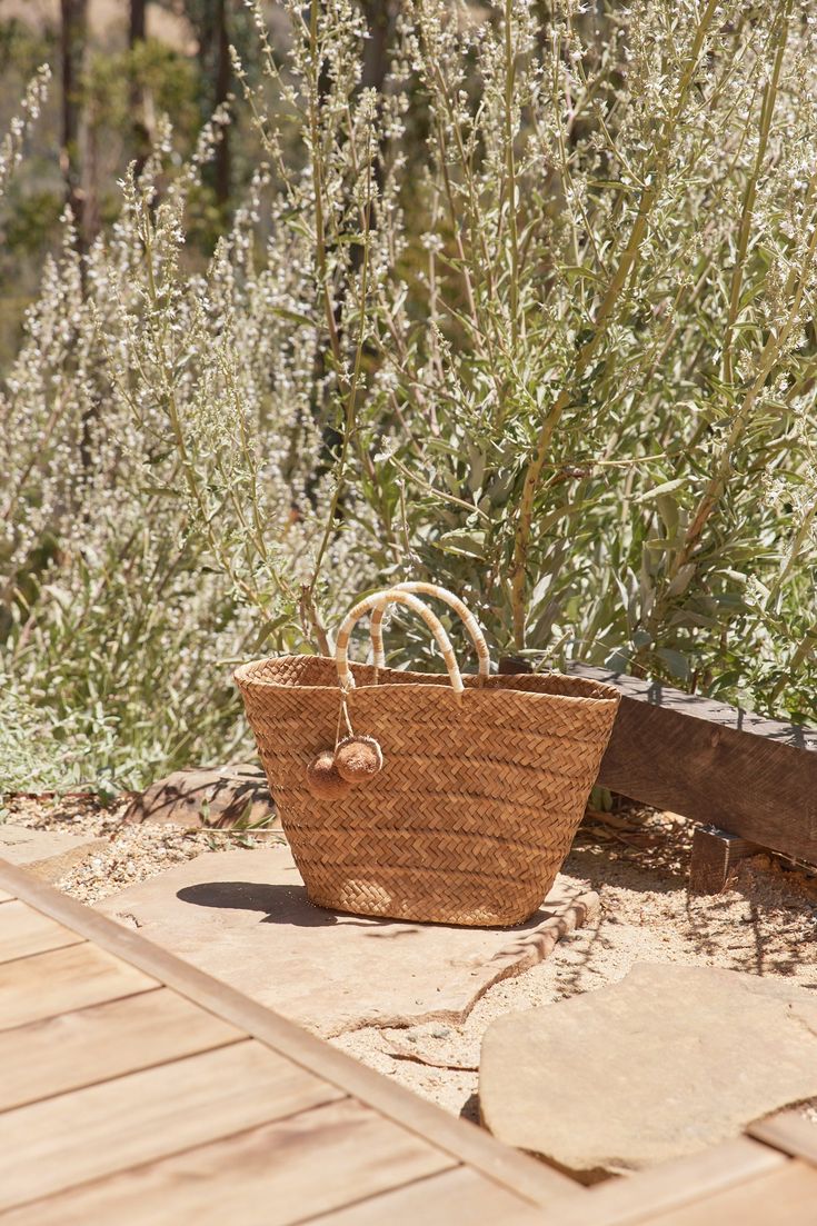 Introducing the Oversized St Tropez. Our best-selling tote now comes in an oversized version that is equally at home in the city as on the coast. Toss in your beach towel and sunscreen for weekend getaways, then use it to carry all your daily essentials once you're back home. Handcrafted from all-natural dried woven seagrass straw using a time-honored Filipino basketweaving technique. Features yarn-wrapped handles with coordinating raffia pompoms. Measures 22" W by 13" H by 6" deep with a 4.75" Summer Weekend Beach Tote Bag, Large Capacity Beach Bag For Summer Weekend, Eco-friendly Beach Bag For Weekend, Summer Beach Bag With Rolled Handles In Natural Color, Summer Natural Beach Bag With Rolled Handles, Natural Beach Bag With Rolled Handles For Summer, Summer Beach Bag For Weekend Vacation, Natural Color Beach Bag With Rolled Handles For Vacation, Natural Beach Bag With Rolled Handles For Vacation