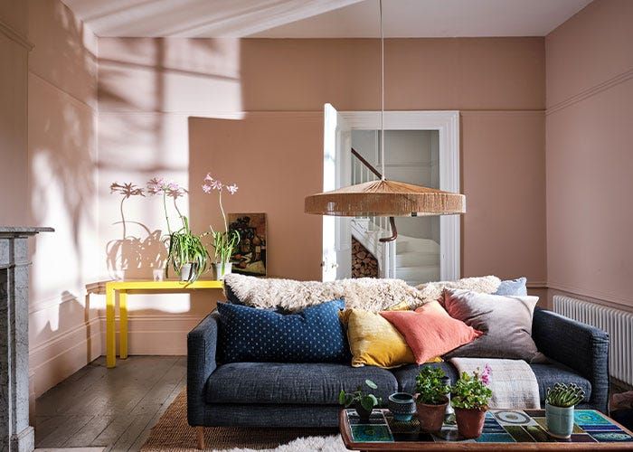 a living room filled with lots of furniture next to a fire place and a window