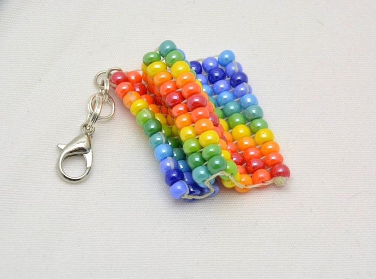 a multicolored beaded keychain on a white surface