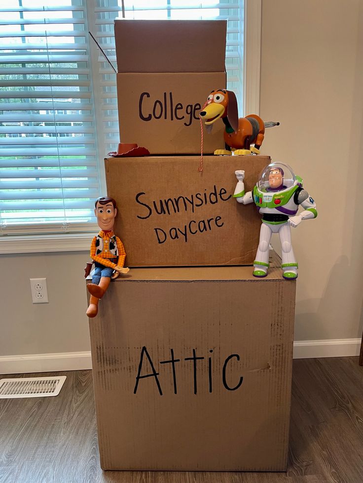 three cardboard boxes stacked on top of each other with toy buzz lightyear and woody the spaceman