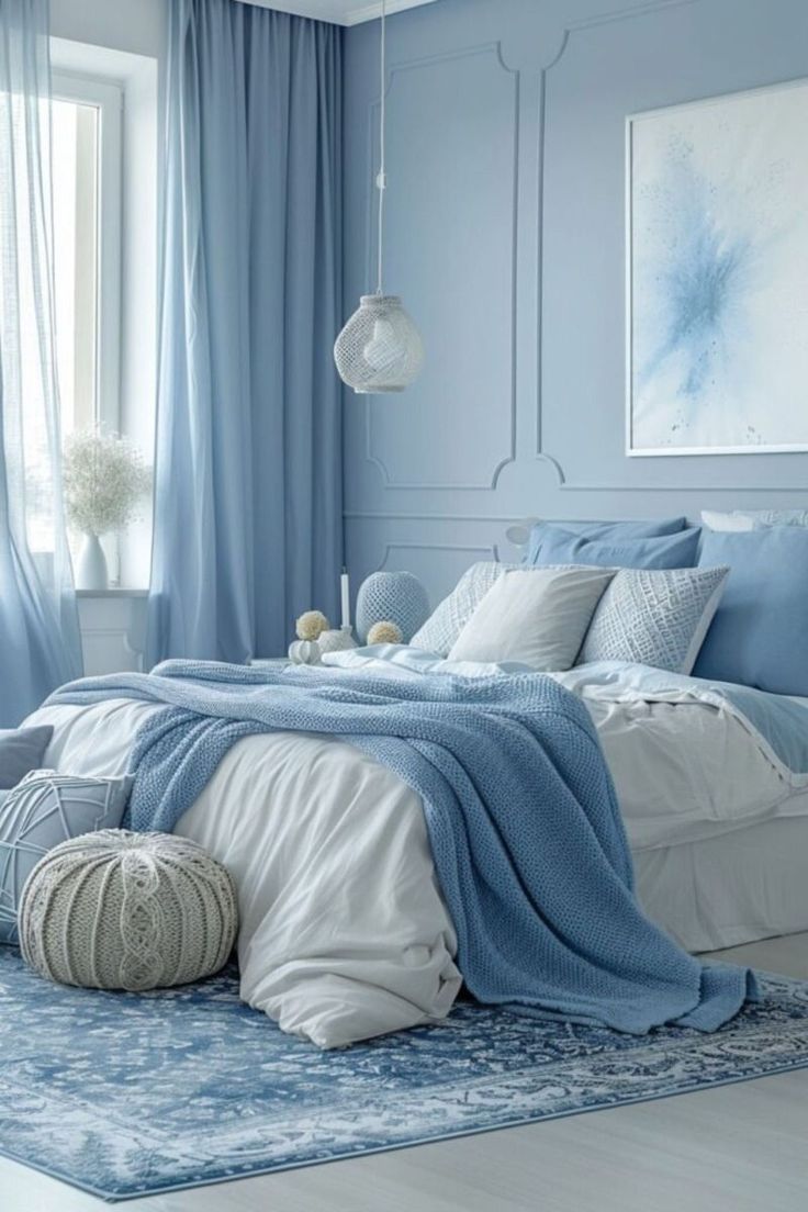 a bedroom with blue walls and white bedding, rugs and pillows on the floor