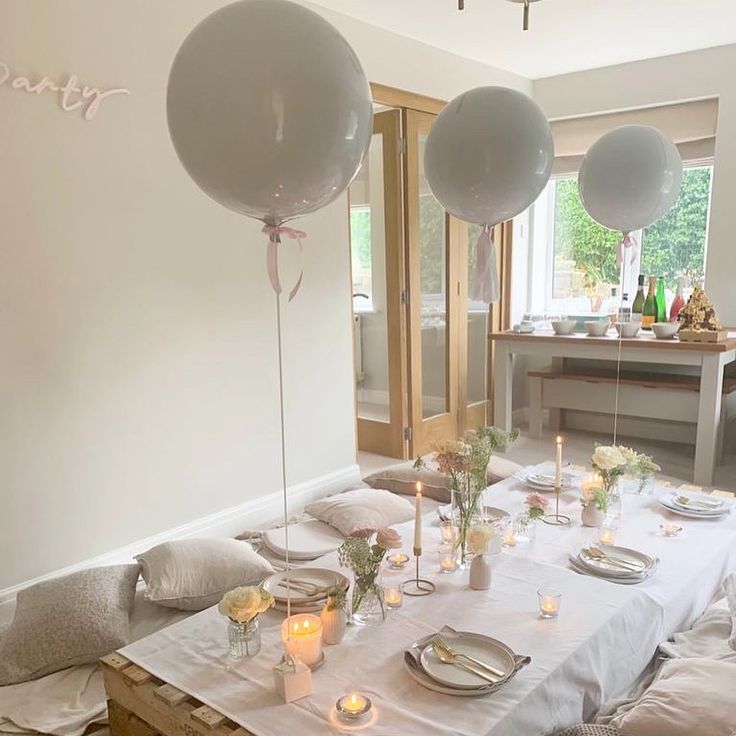 a table with balloons and candles on it