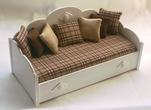 a toy couch with pillows on top of it