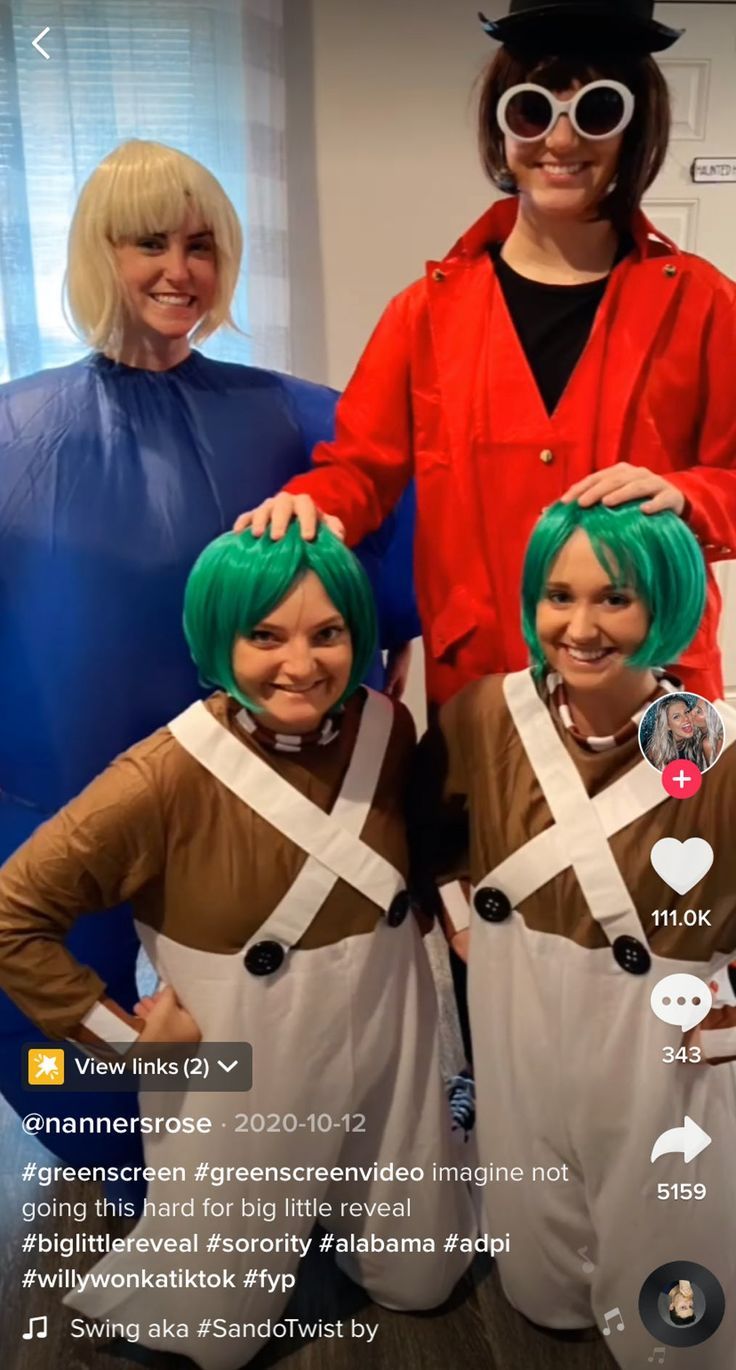 three women in costumes standing next to each other with green hair and white pants on