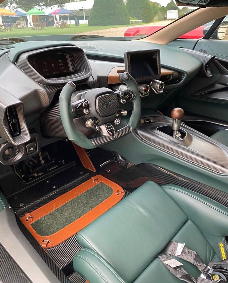 the interior of a sports car with leather seats and dash boards, including an automatic steering wheel