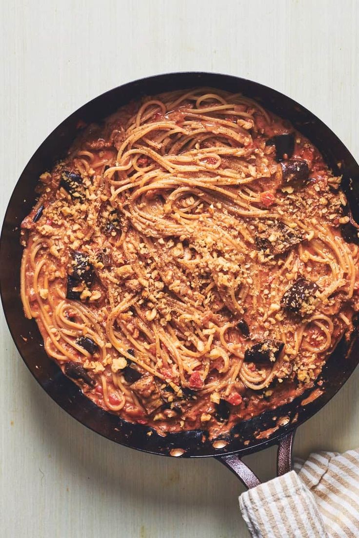 a skillet filled with pasta and sauce