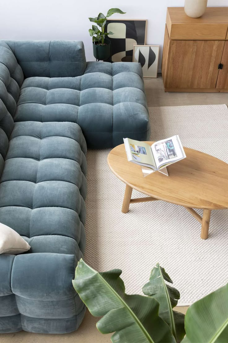 a living room with a blue couch and coffee table