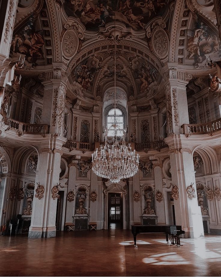 a chandelier hangs from the ceiling in an ornately decorated room with high ceilings