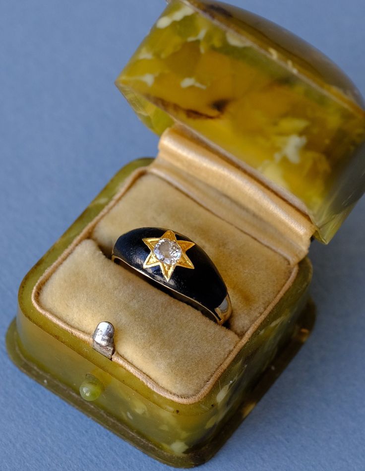 A stunning classic mourning memorial ring, made of 14ct yellow gold (Marked 585) and black enamel, dating back to the late Victorian period, circa 1880s. This striking ring features a sparkling white old European cut diamond claw set in a star setting in yellow gold within black enamel at the center. The shrank is plain. Condition: Very good antique condition with black enamel in good condition Size: Approx. 5.4 US or approx. K-K ½ UK, inside diameter: approx. 16 mm Weight: 3.42 grams ☞  Rings are shipped in antique style velvet boxes that are reproductions of the ones used in 19th century. Victorian Black Engraved Ring In 14k Gold, Antique Black Enamel Rings, Black Enamel Ring For Wedding, 14k Gold Black Enamel Ring For Anniversary, Victorian Oval Enamel Ring For Anniversary, Antique Yellow Gold Signet Ring With Black Enamel, Vintage Yellow Gold Enamel Rings, Antique Black Enamel Signet Ring, Vintage Enamel Ring With Rose Cut Diamonds For Gift