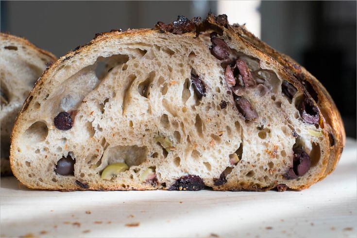 two pieces of bread with raisins and other toppings sitting on a table