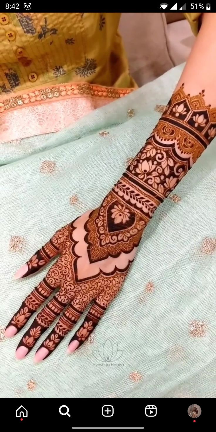 a woman's hand with henna on it