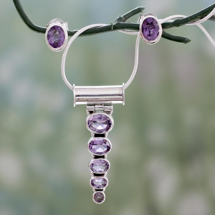 Sleek and modern this jewelry set shows off the allure of amethyst. The lilac gem is associated with spiritual awareness inner peace and positive transformation. Shanker sets five sparkling stones on a pendant and two more in earrings. Sterling silver is his medium. .925 Sterling silver Goddess Crystals, Amethyst Jewelry Set, Crystal Goddess, Amethyst Jewelry, Amethyst Necklace, Handcrafted Earrings, Stunning Jewellery, Jewelry Packaging, Necklace And Earrings