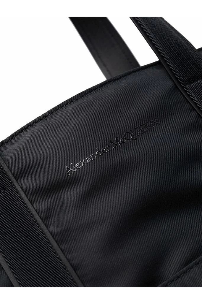 Black leather/fabric logo-embroidered tote from Alexander McQueen featuring embroidered logo to the front and two shoulder straps..Black.100% Calf Leather.Italy.Tote bag.Logo embroidered.Two shoulder straps.Black.Leather with fabric lining Designer Shoulder Bag With Embroidered Logo, Designer Double Handle Bag With Embroidered Logo, Black Bag With Embroidered Logo And Double Handle, Black Bag With Double Handle And Embroidered Logo, Elegant Double Handle Bag With Embroidered Logo, Designer Tote Bag With Embroidered Logo, Luxury Tote Bag With Embroidered Logo, Luxury Double Handle Shoulder Bag With Embroidered Logo, Modern Rectangular Bag With Embroidered Logo