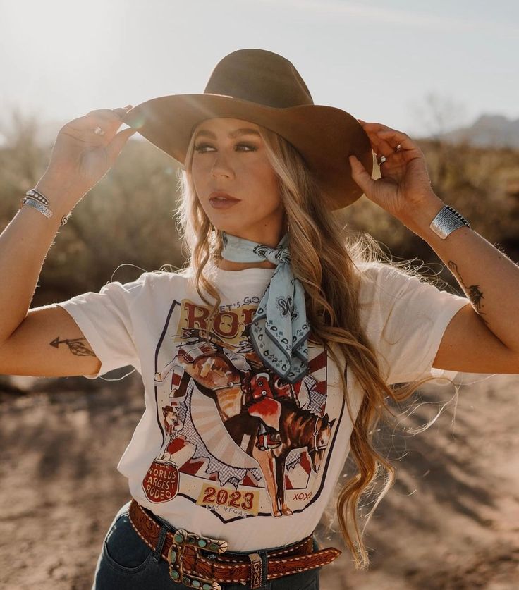 All things western. This tee is perfect for any rodeo during any season! Crew Neck | Short Sleeve | Unisex Fit Bella Canvas Material: 100% CottonSmall (2/4) | Medium (6/8) | Large (10/12) | XL (14/16) | 2XL (18/20) Western Style Cotton T-shirt For Rodeo, Western Style T-shirt For Ranch In Summer, Western Style Summer T-shirt, Western Tops For Country Concerts In Summer, Western Style Tops For Country Concerts And Festivals, Western Cotton Tops For Country Festivals, Country Style T-shirt For Western-themed Summer Events, Western Style T-shirt For Rodeo, Casual Tops For Rodeo And Country Festivals