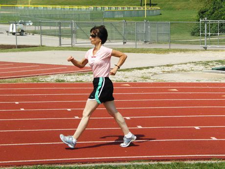 a woman running on a race track