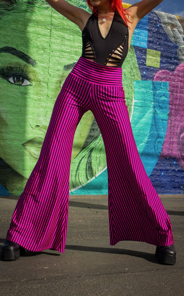 The Pink & Black Stripe Big Bells are your go-to stylish everyday pant. Dress these flattering pants up or down- truly perfect for almost any occasion. Design Features: High waistband hits comfortably at your true waist Waistband can be rolled down to expose belly Perfectly hugs hips Pant leg flares into large bells Fantastic garment to dress up and down. Incredibly vibrant print. Made in San Francisco, CA, USA Fabric Features: Radical vertical Pink and Black stripe. Moisture Wik Polyester/Spand High Waist Yoga Pants With 4-way Stretch For Spring, Versatile Stretch Harem Pants For Spring, Chic Summer Yoga Bottoms, Spring Yoga Stretch Wide Leg Pants, Versatile Elastic Bottoms For Spring, Elastic Bottoms For Night Out, Trendy Stretch Harem Pants With Elastic Waistband, Spring Wide Leg Bottoms With 4-way Stretch, Trendy Wide Leg Yoga Pants