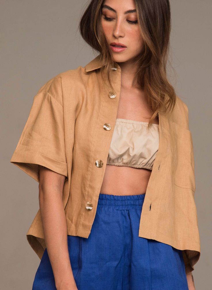 With structured and cropped cut, boxy silhouette and tailored details, wearing our Leia Shirt feels stunning and natural. What we love about it is its versatility. You can wear it closed or as a complement over another top. It has a boxy fit and oversized cut at the shoulders, which gives it a fun and relaxed look. Pair it with the Carpenter Pant for a monochromatic look. COMPOSITION AND CARE Material: 100% linen Linen is one of the most sophisticated natural fiber fabrics. It does not hold or b Summer Cropped Hem Tops For Work, Summer Workwear Tops With Cropped Hem, Cropped Linen Workwear Tops, Chic Boxy Cropped Top, Spring Boxy Workwear Tops, Spring Boxy Tops For Workwear, Versatile Cropped Linen Tops, Chic Neutral Cropped Tops, Chic Cropped Neutral Tops