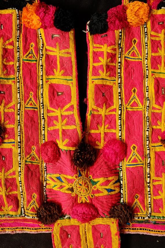 This is an Indian tribal child's vest front section from the Banjara ethnic group.  It is in embroidered cotton.  Very ethnographic and makes a wonderful and attention grabbing piece. -Banjara child's vest-A nice ethnographic article for displaying-Top to bottom: 52 cm; Width: 54 cm Festive Bohemian Vest, Bohemian Multicolor Choli For Ceremonial Occasions, Bohemian Multicolor Embroidered Vest For Festivals, Bohemian Choli For Ceremonial Festivals, Traditional Cotton Vest For Festivals, Traditional Cotton Choli For Festival, Bohemian Multicolor Ceremonial Choli, Traditional Multicolor Vest For Festival, Bohemian Cotton Choli With Motifs