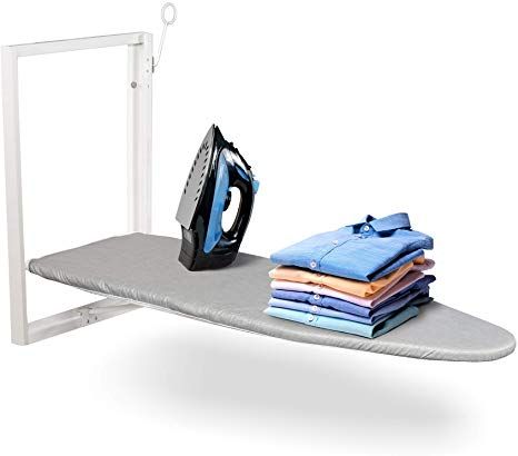 an ironing board with clothes on it next to a black and white electric iron