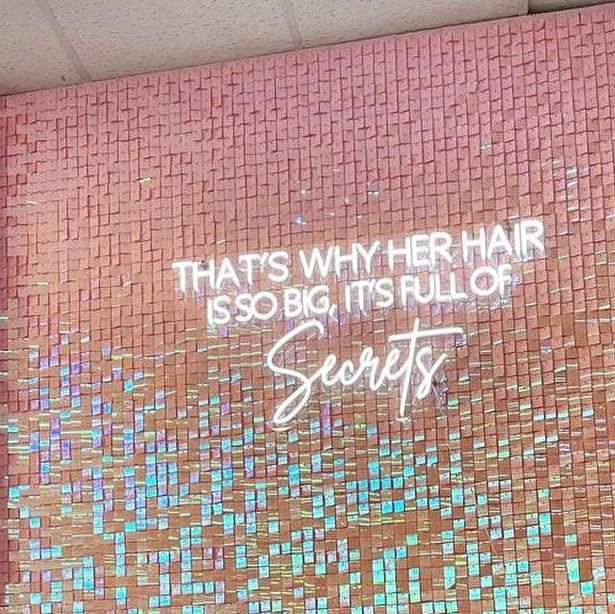 there is a sign that says, that's why hair is so big it's full of secrets