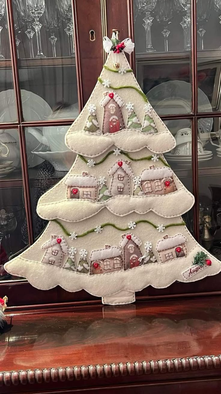 a white christmas tree sitting on top of a wooden table