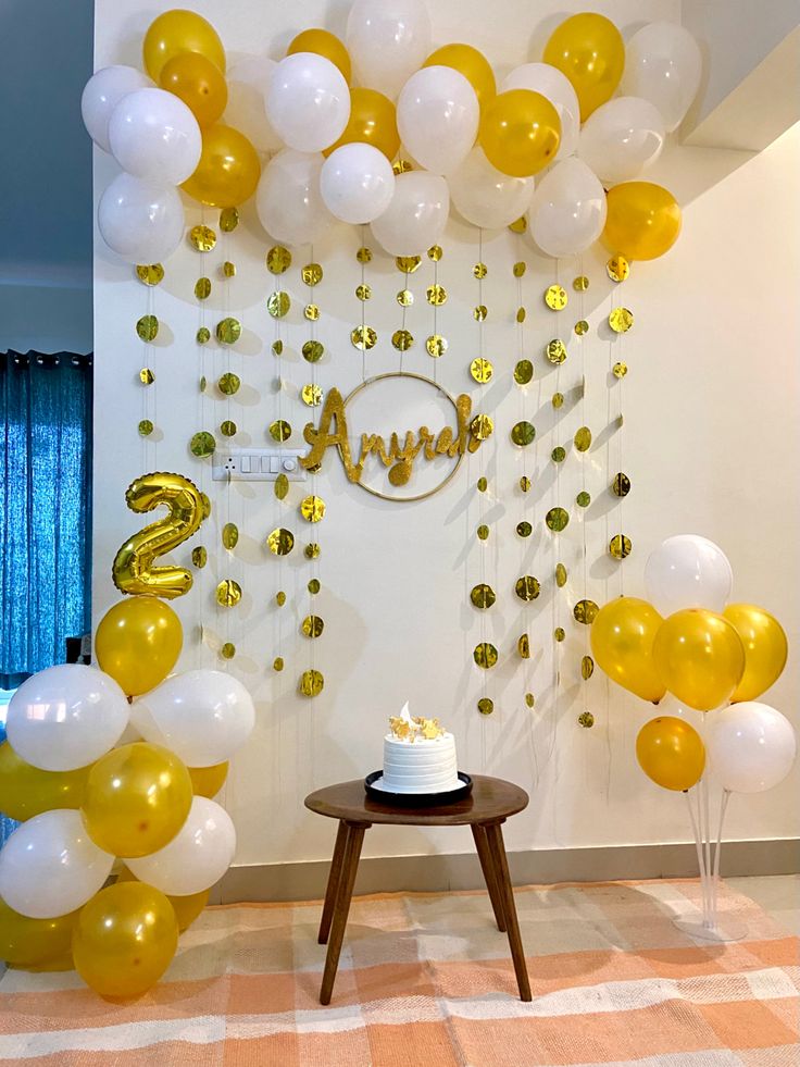 a birthday party with balloons, cake and streamers