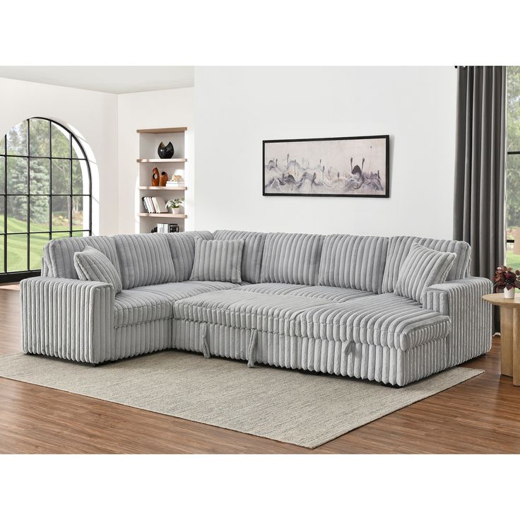 a living room with a sectional couch and rug