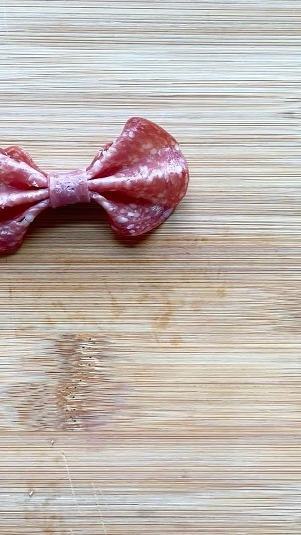 a dog bow tie on top of a wooden table