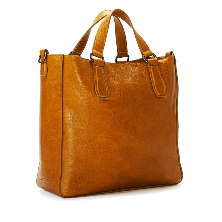 When you first pick it up, you’ll notice our Ellington Market Tote is not only a work of art, but also amazingly light. Open it and you'll quickly realize it's also an organizational wonder with a large hanging pocket w/ pen slot and an included detachable Ellington Large Zippered Pouch. Attach the included adjustable leather strap and wear it crossbody, or detach it to slip over your elbow for a quick trip to the market. A strong magnet closure for quick opening / secure closing completes the p Luxury Rectangular Pouch With Zipper Pocket, Classic Rectangular Shopping Pouch, Modern On-the-go Satchel Pouch, Luxury Everyday Pouch With Zipper Closure, Luxury Shoulder Bag Pouch For Everyday Use, Modern Leather Pouch With Leather Lining, Luxury Tote Pouch For Everyday Use, Modern Cognac Bag With Leather Handles, Modern Cognac Bags With Leather Handles