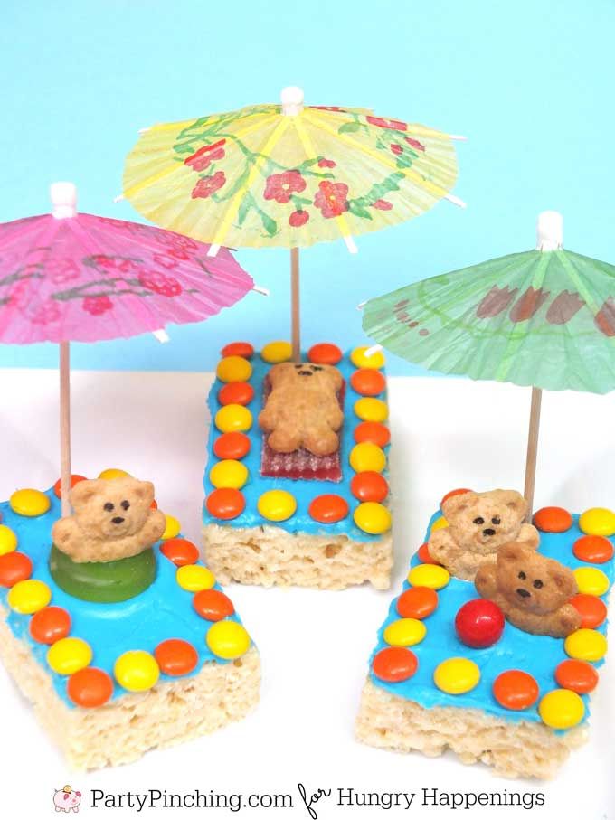 there are three small cakes with bears on them and some umbrellas above the cake