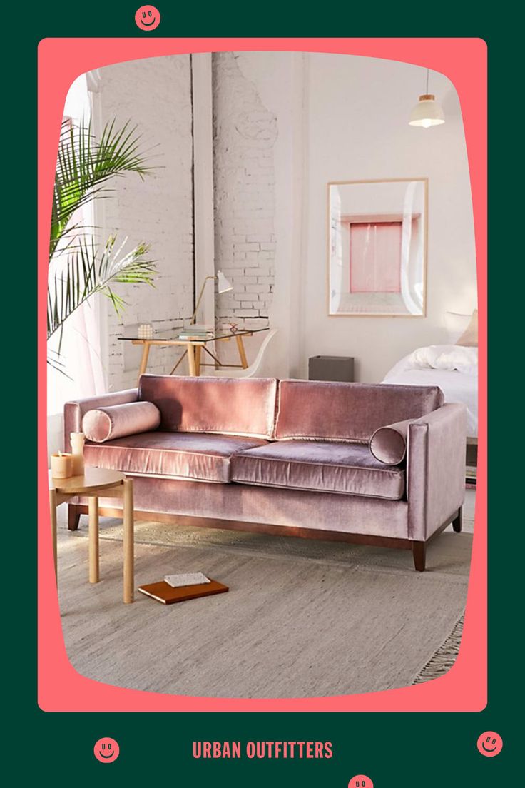 a living room with a pink velvet couch