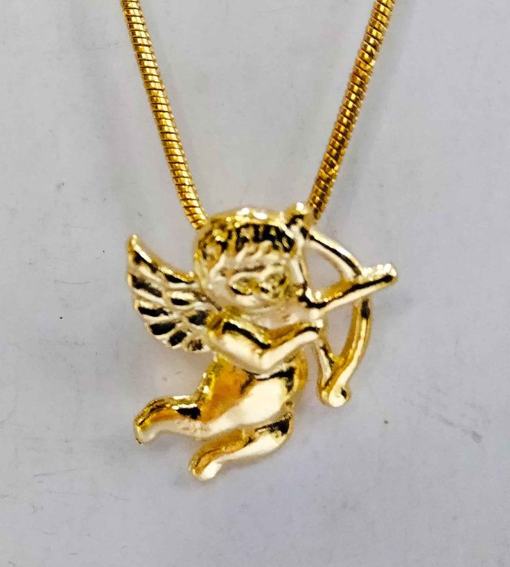 Dimensions: 2 cms x 1,2 cms pendant in 18k, 14k or 9k. Also available in 18k gold plated silver (high quality 925 sterling silver with 3 microns of 18k gold). with option to goldfilled chain 18k gold plated All my gold jewelry is made to order. I need about 10 days to manufacture it plus the days necessary for shipping. In Greece was invoked, under the name of Eros to achieve love in the couple. Cupid is the angel of love.  CUPID OR GOD EROS STORY In Greece, dome was known as Eros, he was the son of Aphrodite the goddess of love, beauty and fertility. For the Romans he was known as Cupid and is the god of love son of Venus and Mars, PROPERTIES OF THE CUPID ANGEL   The Cupid angel pendant is a very powerful amulet if you want to find a partner, or fall in love with someone you already know. Angel With Bow And Arrow, Love Amulet, Cupid Necklace, Arrow Pendant, Bow And Arrow, Angel Pendant, Jewel Necklace, Goddess Of Love, Chain Gold