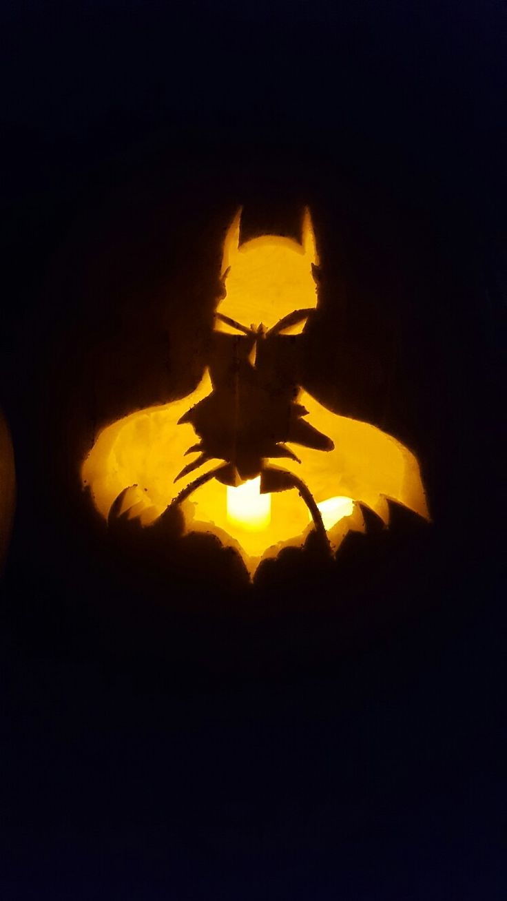 a close up of a carved batman pumpkin