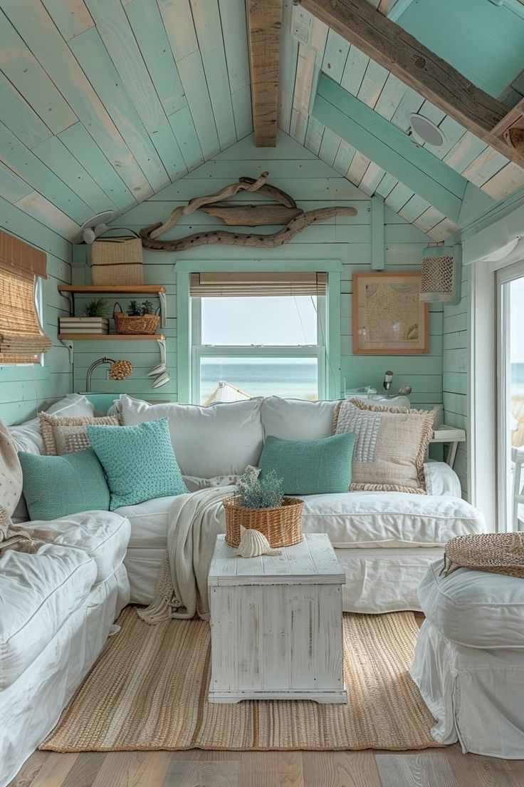 a living room filled with white furniture and lots of pillows on top of it's walls