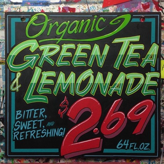 a sign advertising organic green tea and lemonade