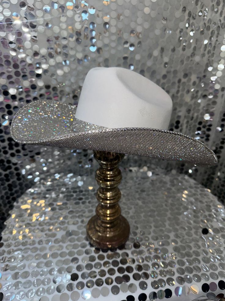 The original "Rhinestone Cowgirl" Rhinestone Party Hat For Kentucky Derby, Western Silver Hats For Parties, Western Style Silver Hats For Party, White Party Hat With Rhinestones, Silver High Crown Hat For Party, High Crown Silver Hat For Party, Fitted Tall Crown Hat For Party, Rhinestone Fitted Hat For Kentucky Derby, Fitted Rhinestone Hat For Kentucky Derby