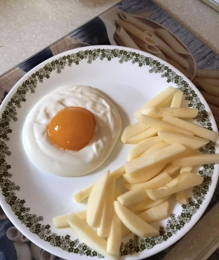 an egg and some fries on a plate