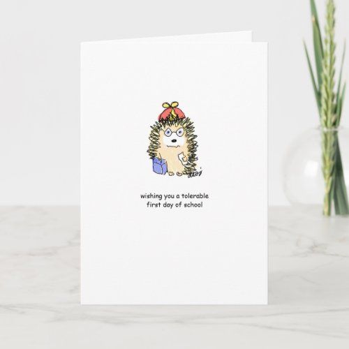 a card with an illustration of a hedgehog holding a box and the words, wishing you a special first day of school