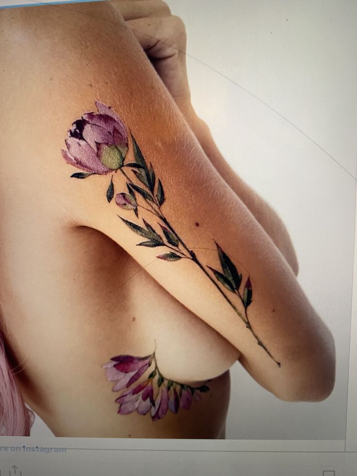 a woman's breast with flowers on it