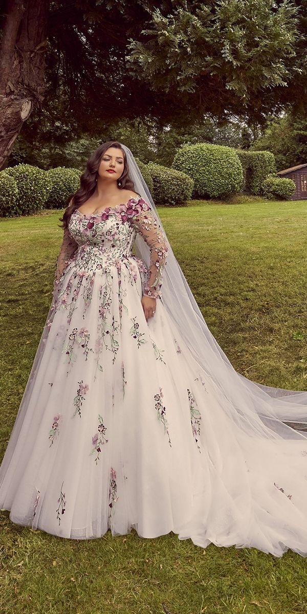 a woman in a wedding dress posing for the camera