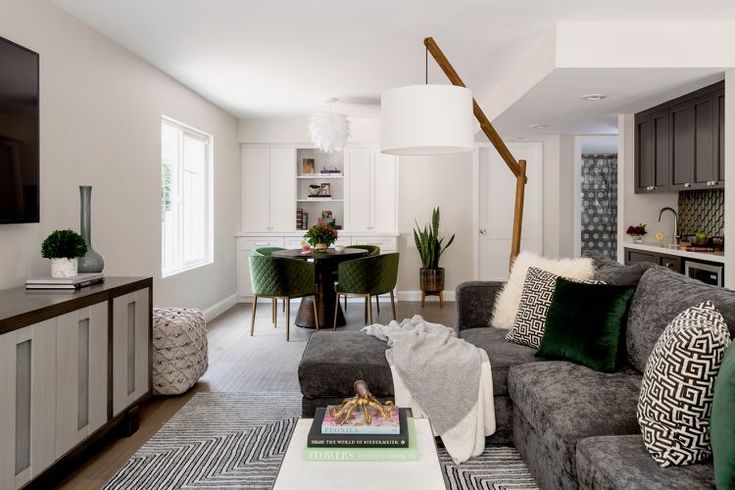 a living room filled with furniture and a flat screen tv mounted to the side of a wall