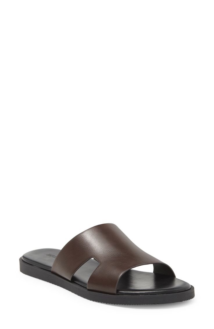 A cutout vamp adds a breezy feel to this vacation-ready slide sandal fashioned with a cushioned footbed. Synthetic upper, lining and sole Imported Classic Slip-on Slides For Summer, Beach Slides With Ortholite Insole And Open Toe, Classic Textured Open Toe Slides, Classic Leather Footbed Flip Flops For Vacation, Classic Slip-on Footbed Sandals For Summer, Classic Footbed Sandals For Summer Vacation, Classic Summer Footbed Sandals For Vacation, Modern Leather Flip Flops For Vacation, Summer Travel Slip-on Sandals