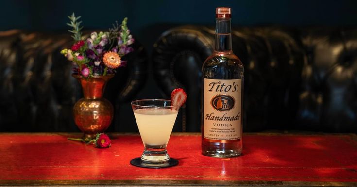 a bottle of alcohol sitting next to a glass on a table