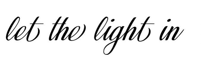 the words let the light in are black and white, with one handwritten word above it