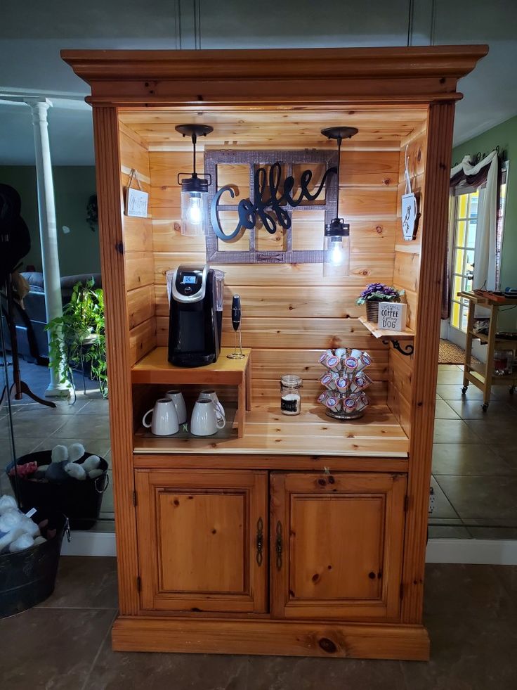 a coffee bar with wooden cabinets and lights