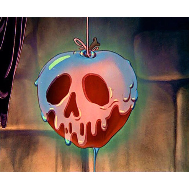 an apple shaped like a skull hanging from a hook with water dripping down it's side