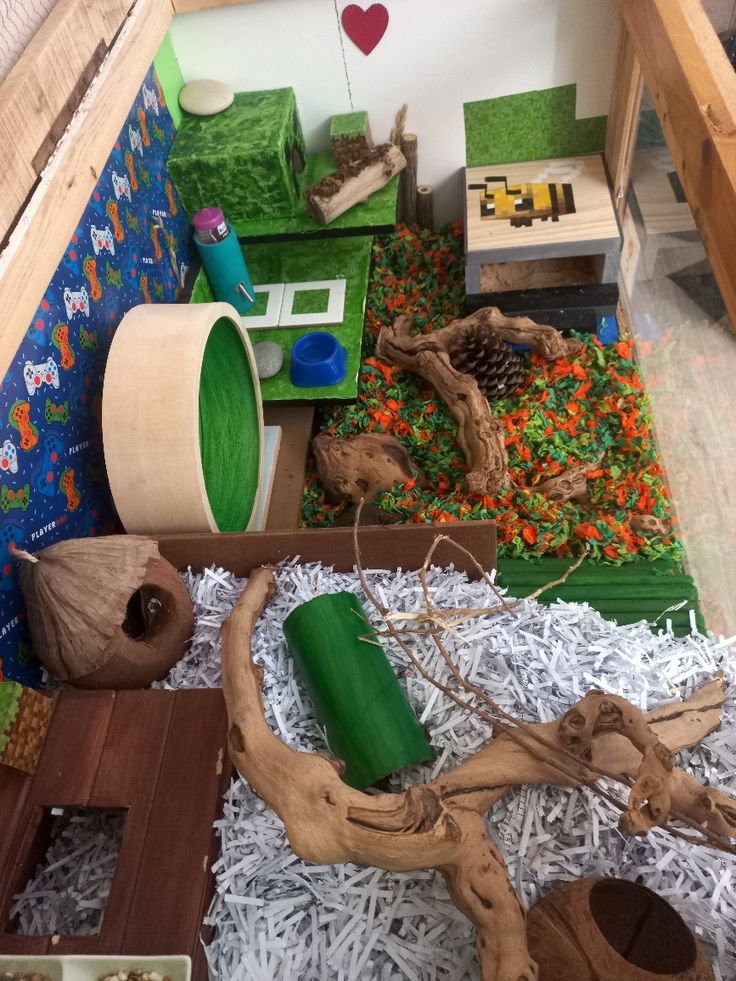 an indoor play area with toys and other items in it, including fake wood logs