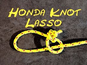 a yellow rope with the words honda knott lasso written in white ink