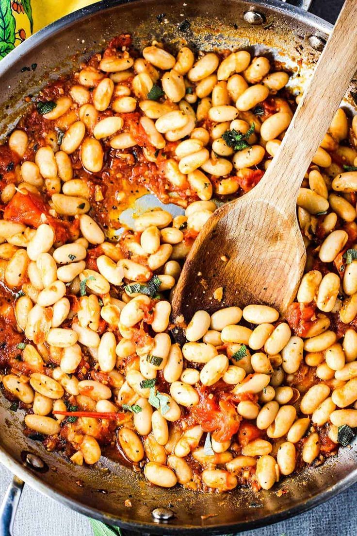 a skillet filled with beans and tomatoes