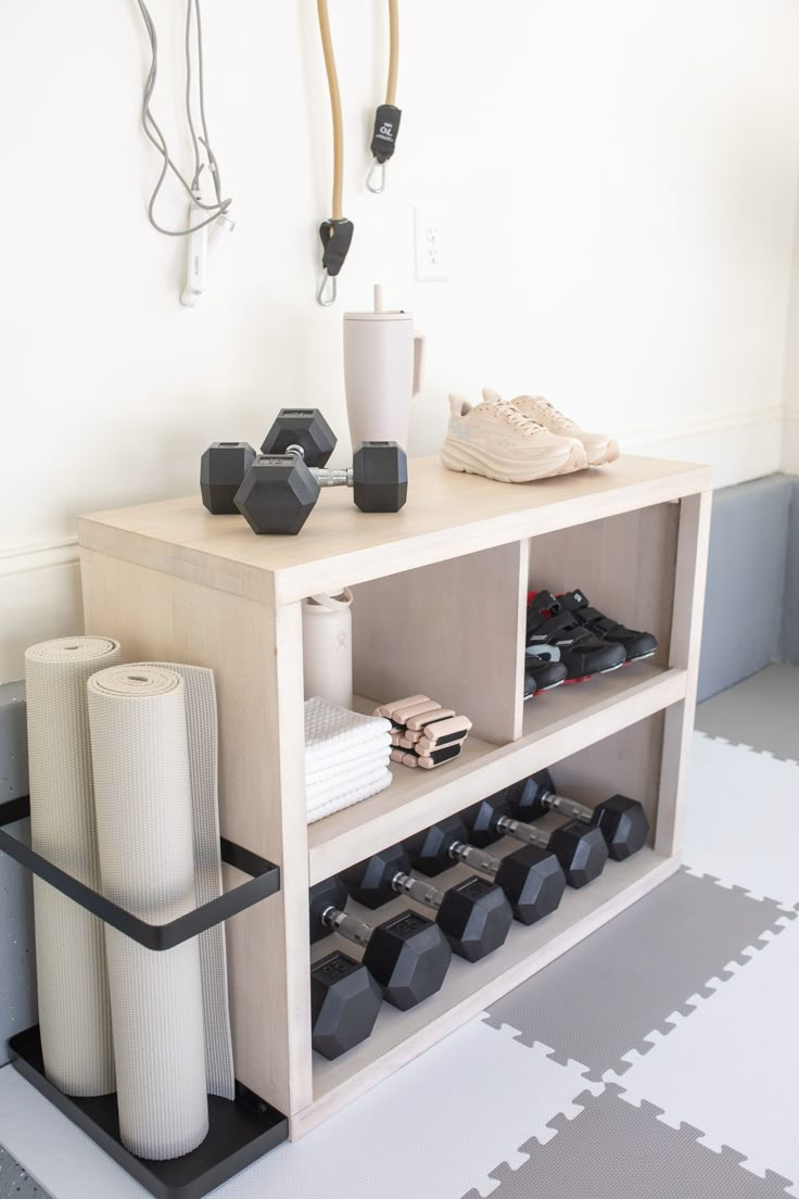 a shelf with various items on it in a room that is white and has gray flooring